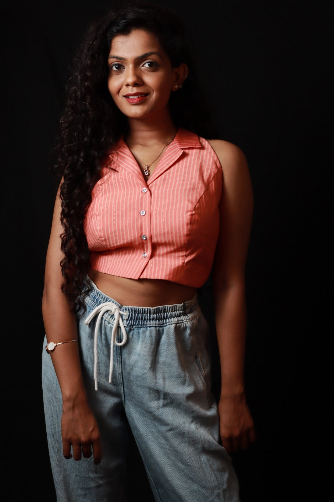 peach coloured sleeveless collared top with vertical stripes and buttons down (only top)