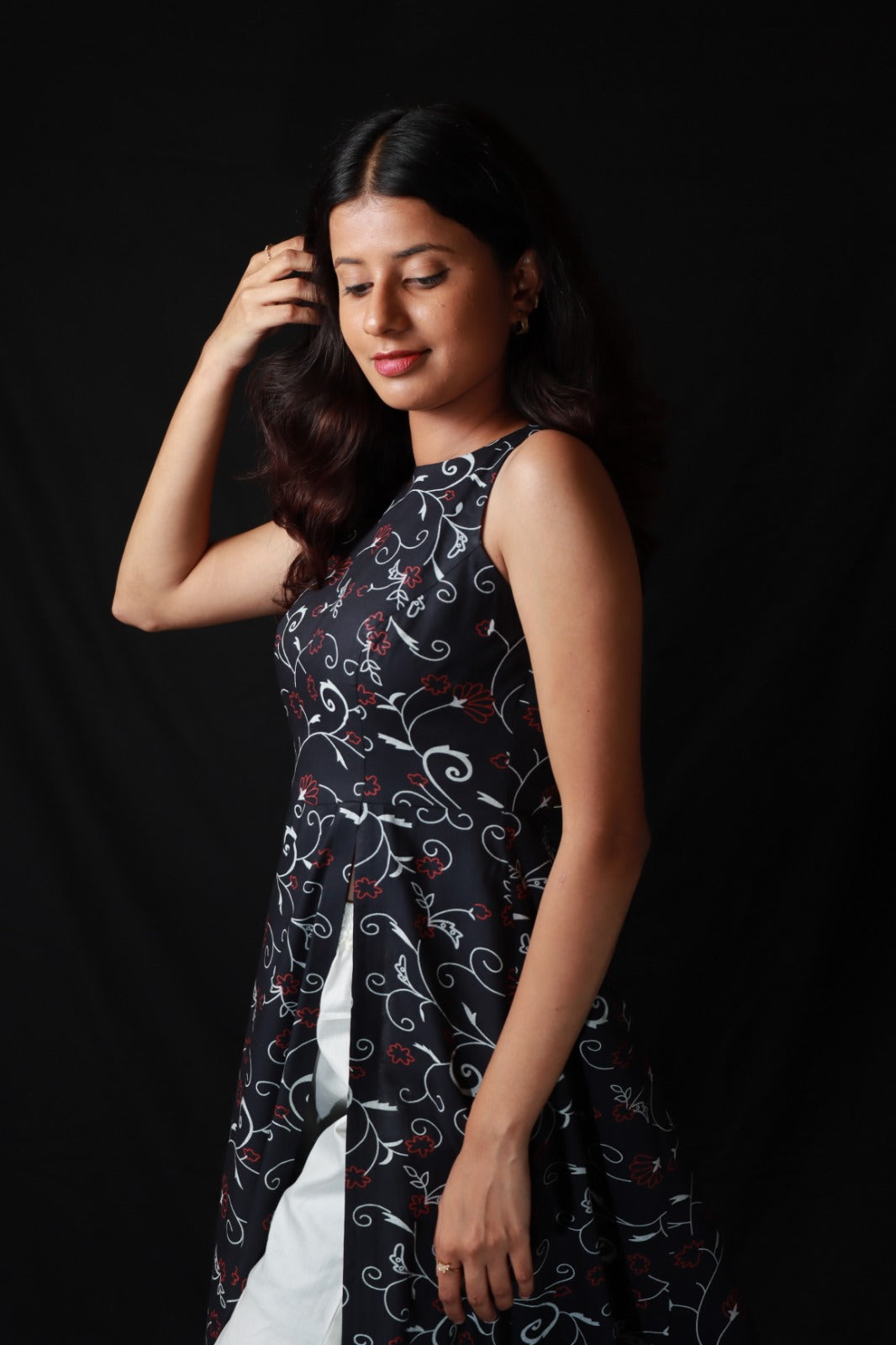 Patterned long kurta with side slit worn over with wide legged white pants