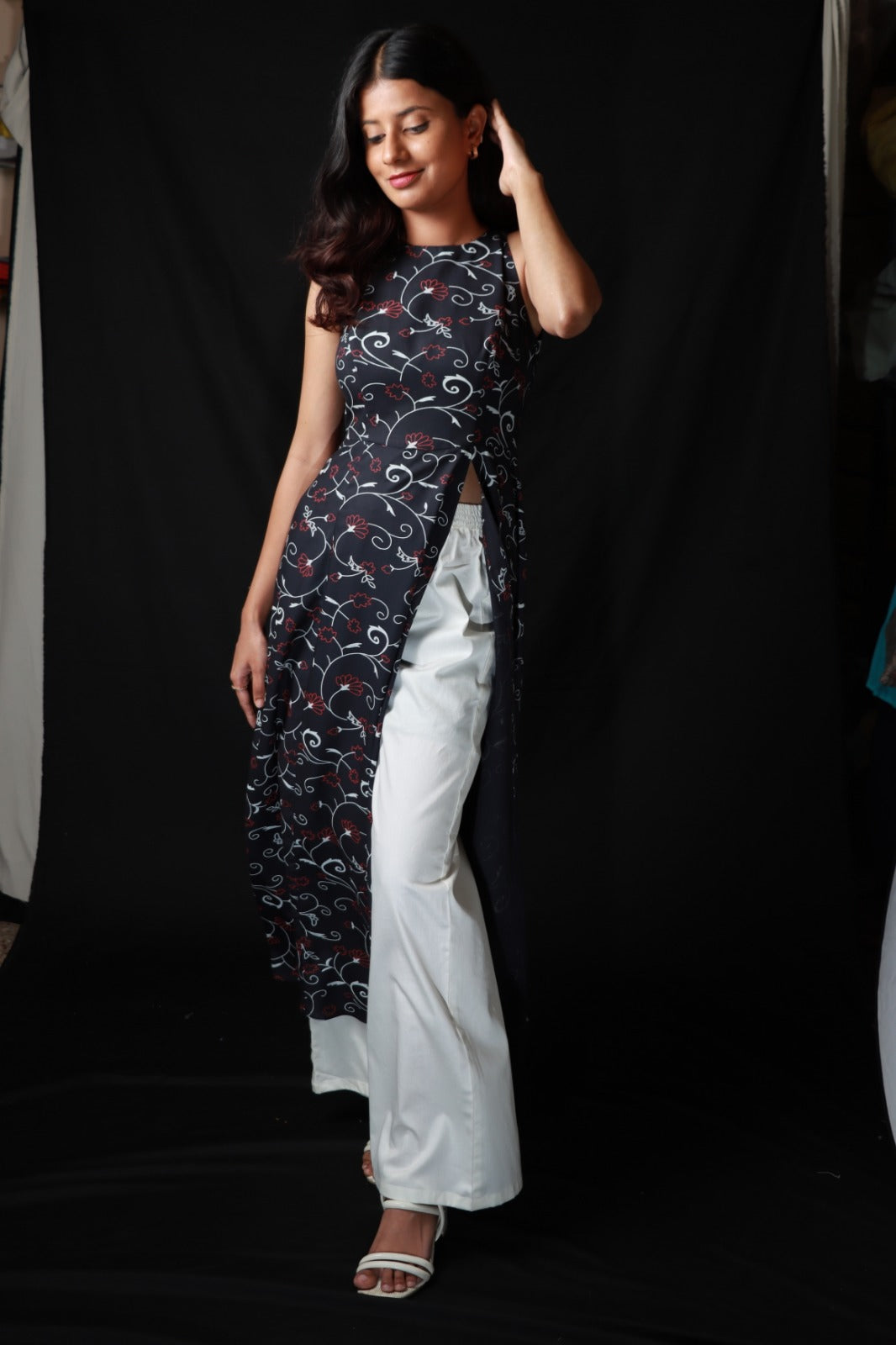 Patterned long kurta with side slit worn over with wide legged white pants